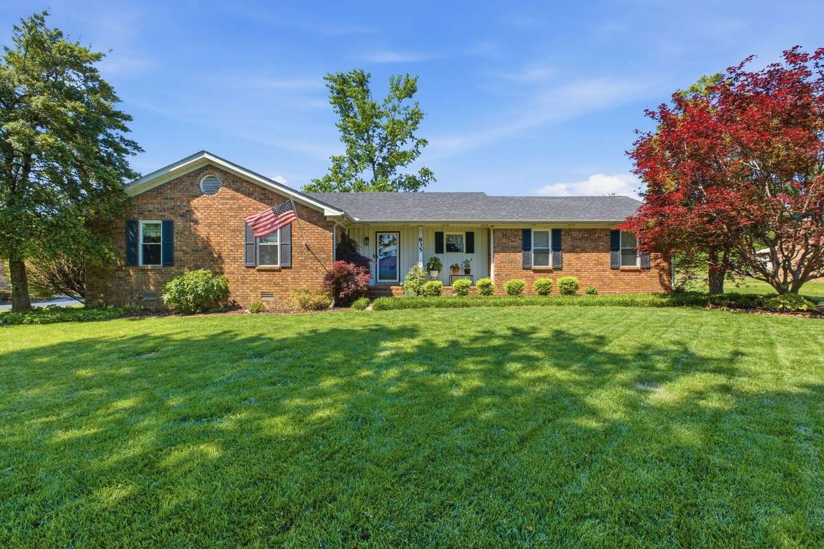 Welcome home to wide-open space, mature trees, and classic brick charm.