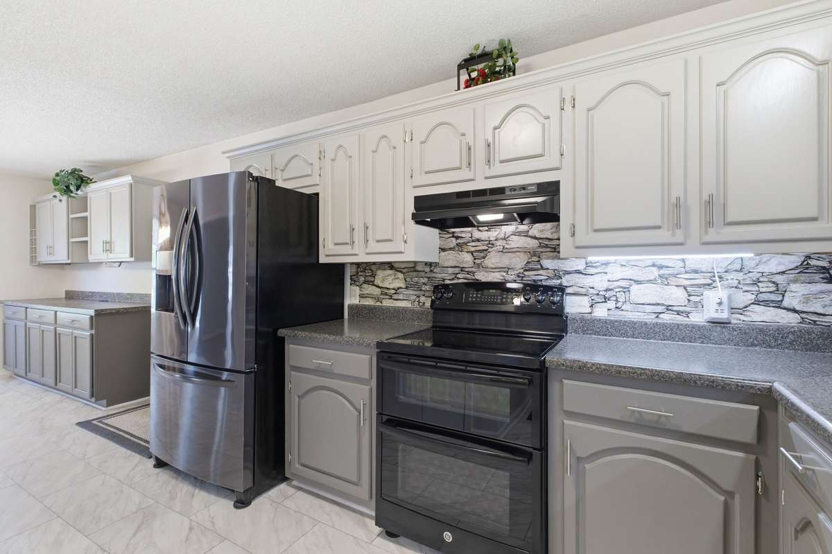 Abundant cabinetry and updated finishes offer both style and storage.