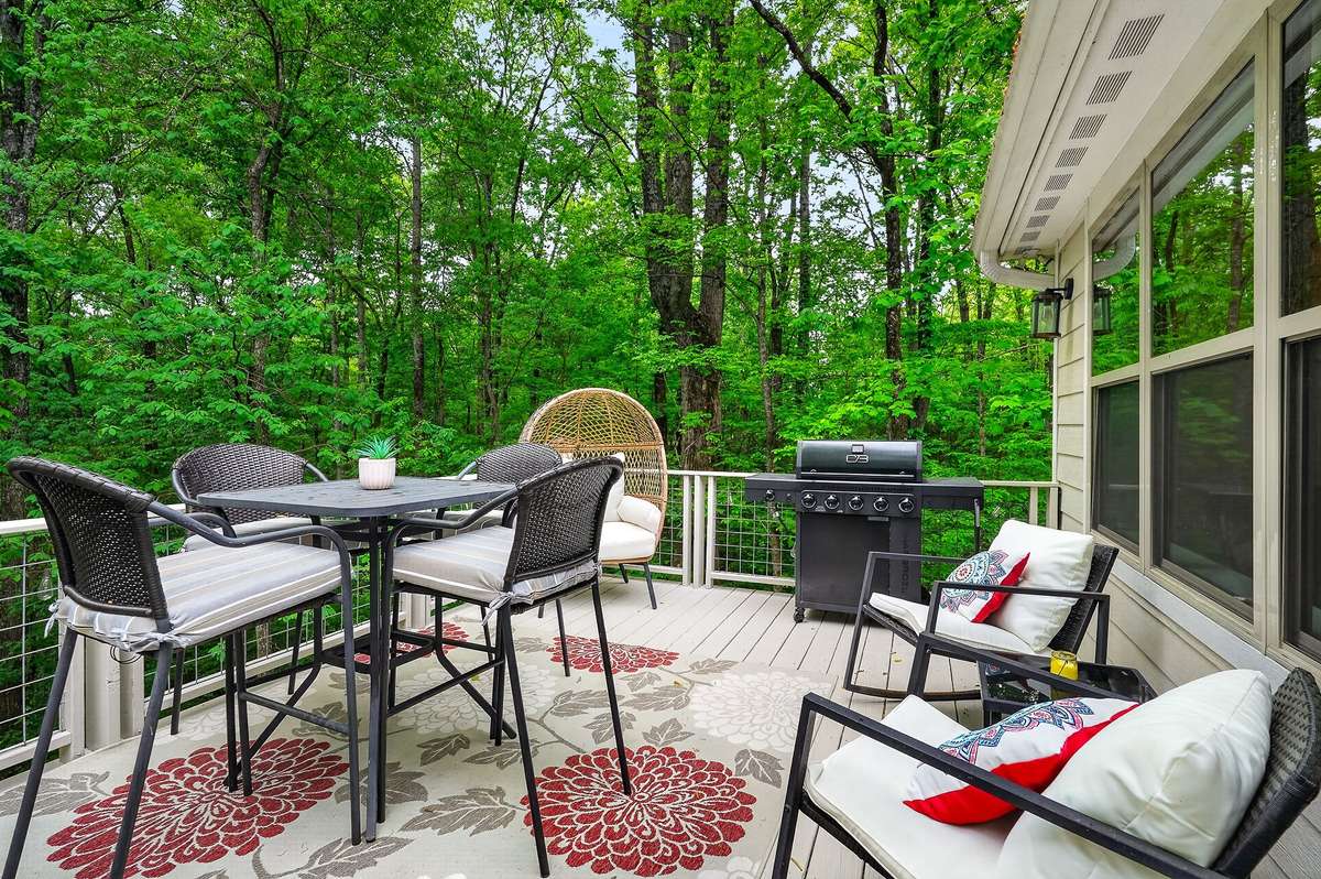 Outdoor living on expansive two-story deck and patio.