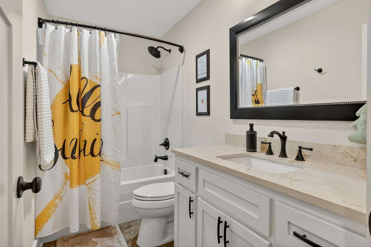 Shared guest bath with ample counter space.