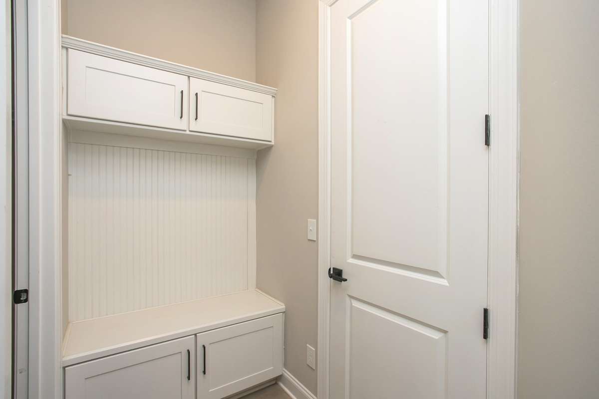 Drop zone off garage with a large storage closet to the left