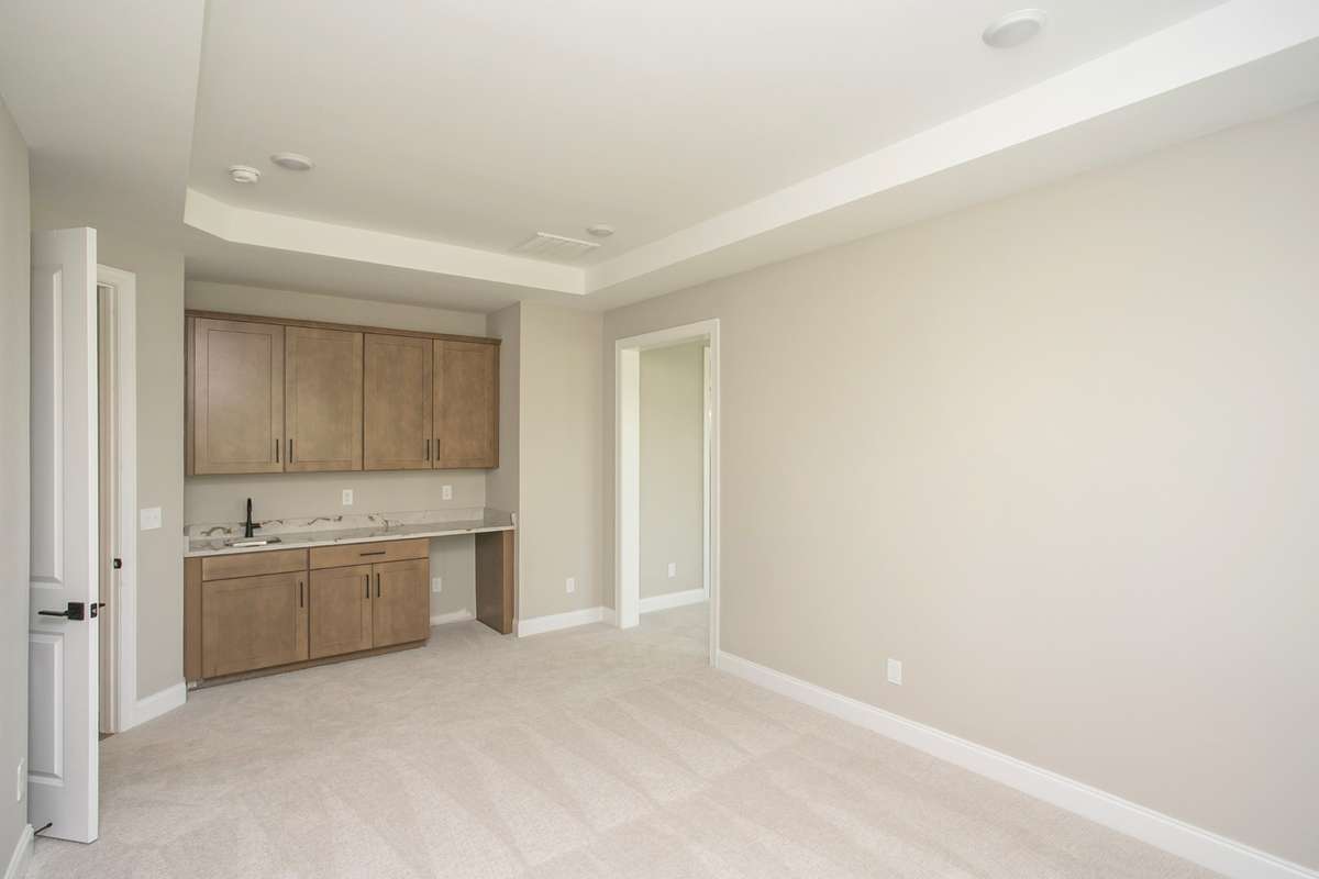 Private Master Den with wet bar and cabinetry