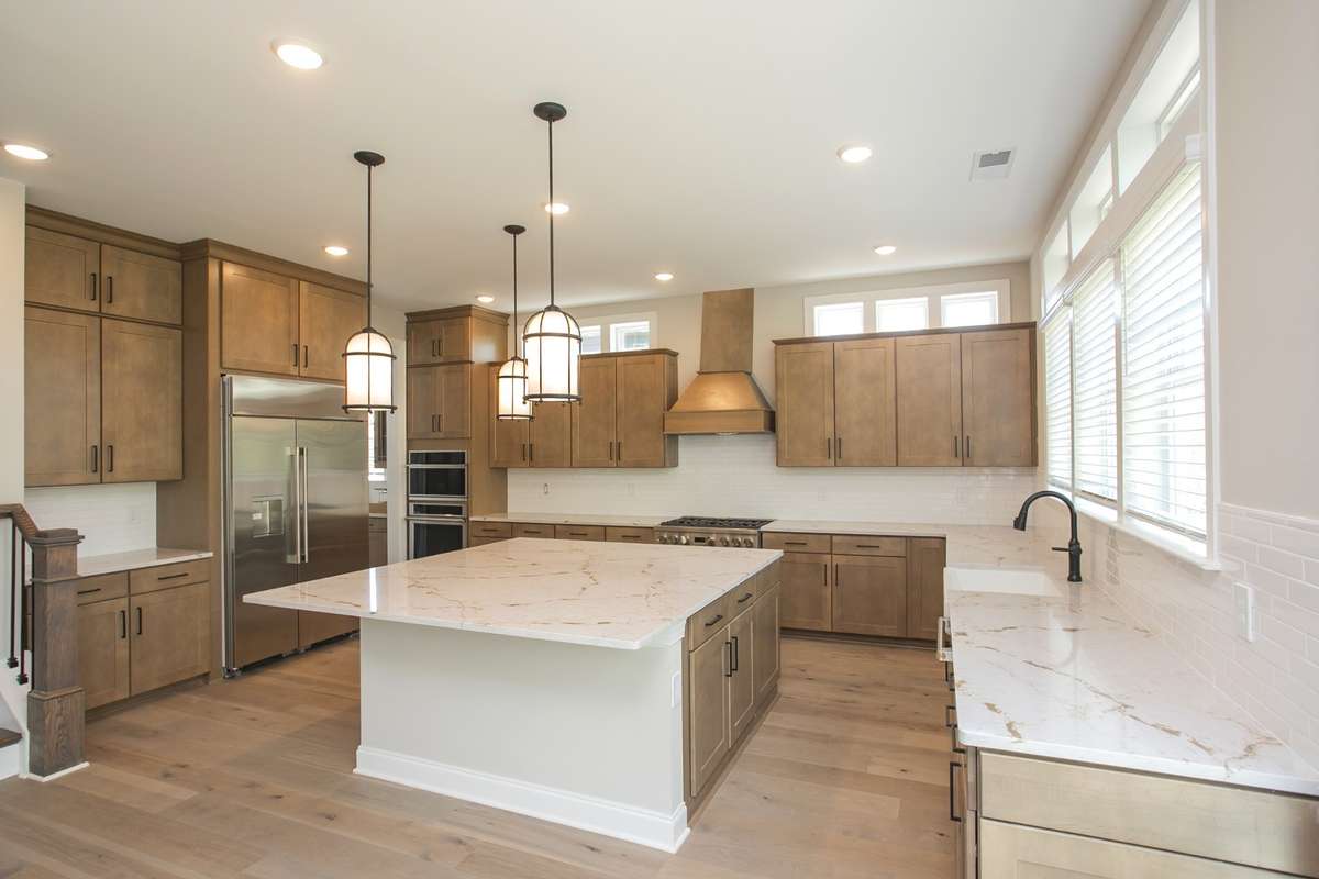 Gourmet kitchen has GE Monogram appliances, two dishwashers, two ovens