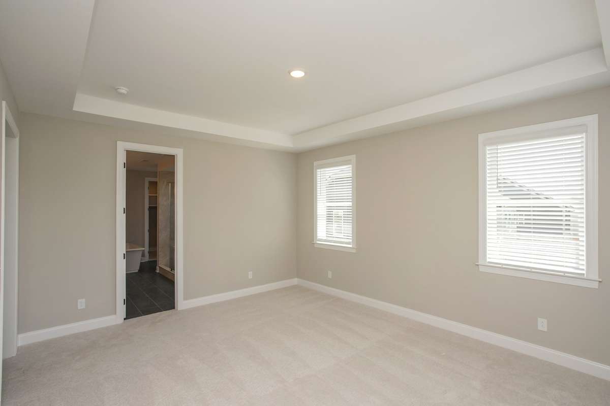Master bedroom and entrance to spacious spa master bathroom and his and her walk in closets