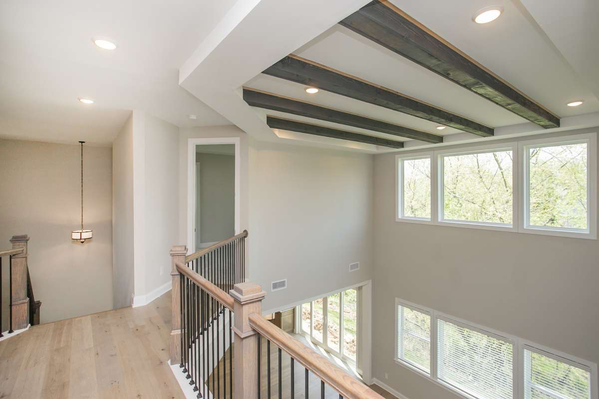 2nd floor walk way goes between private master on the left side of the house with the other three bedroom with dedicated private bathrooms on the right side of the house with 2nd floor laundry
