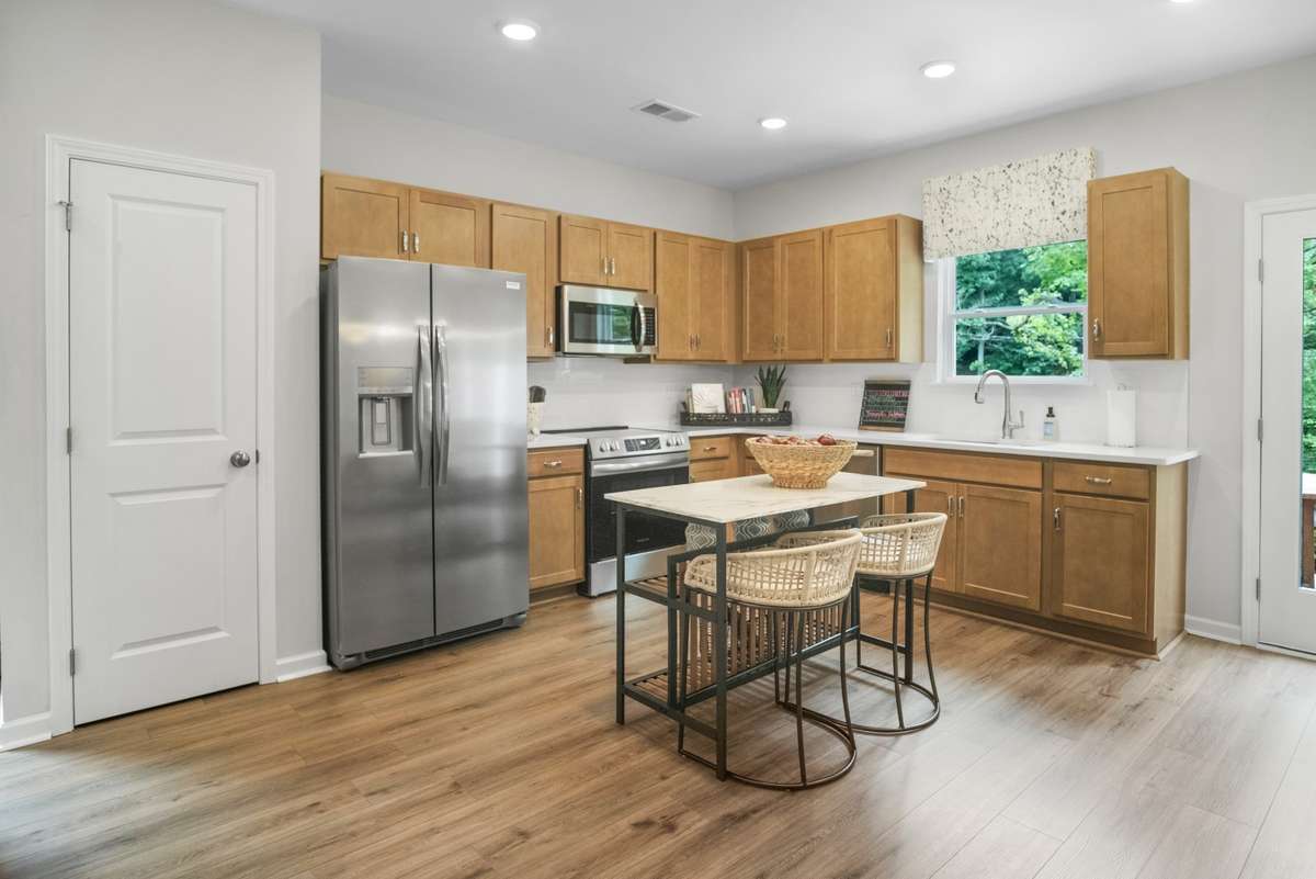 This picture is from our furnished and decorated model home in the community.  Window placement and color scheme may vary per unit location.  Kitchen will feature a permanent island.  Ask agent for more specific details regarding colors and options.