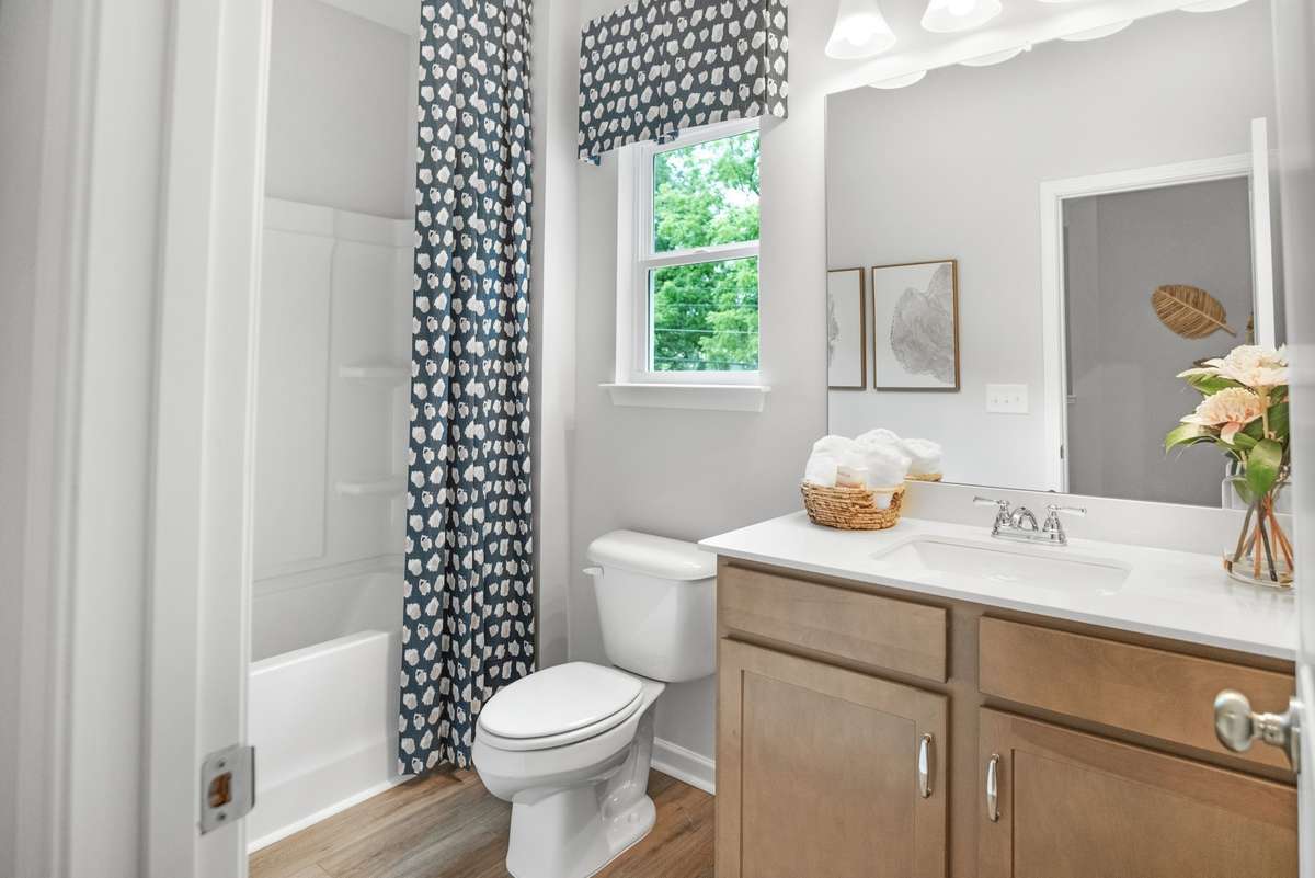 Secondary Bathroom-This picture is from our furnished and decorated model home in the community.  Window placement and color scheme may vary per unit location.  Ask agent for more specific details regarding color and options