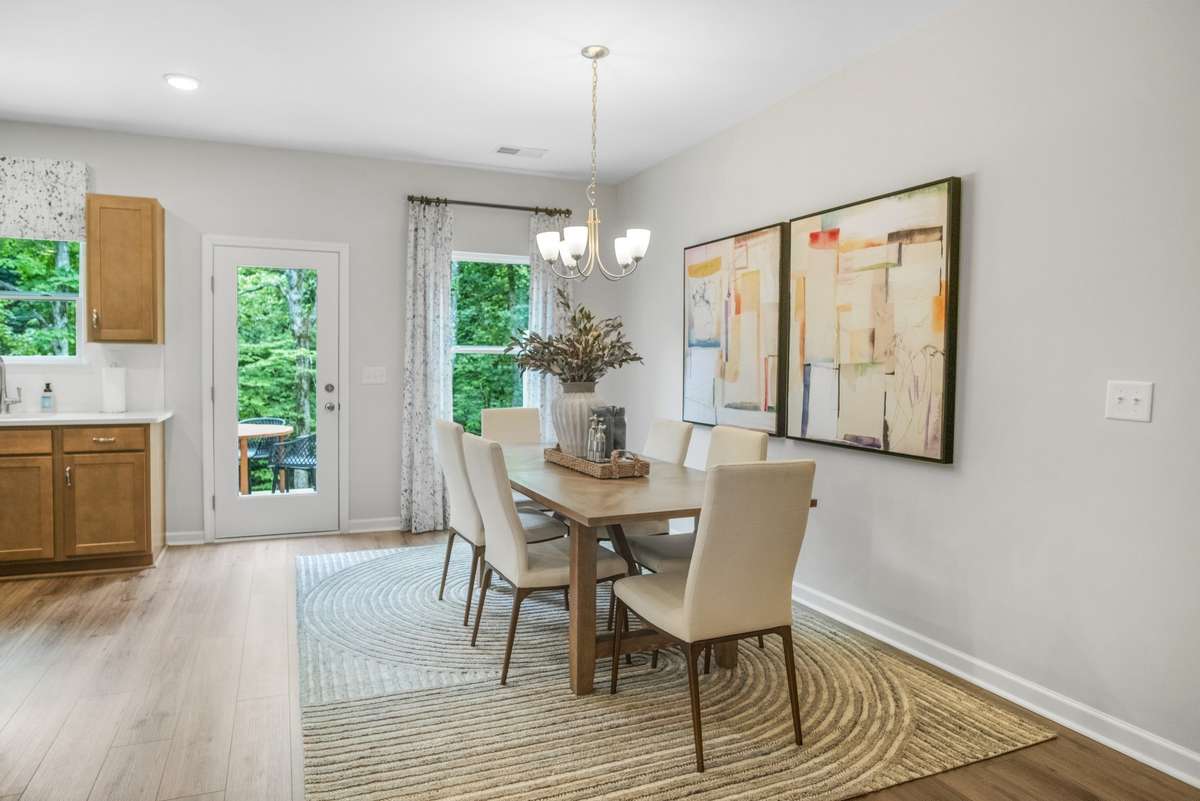 Got to love the designated dining area in the Pinehurst plan.  This picture is from our furnished and decorated model home in the community.  Window placement and color scheme may vary per unit location.  End unit will have extra side windows in DR.