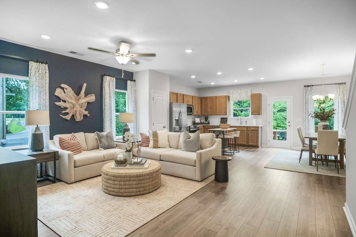 Our Pinehurst is an open plan featuring an entry foyer, large living area, designated eating area and permanent island.  This picture is from our furnished and decorated model home in the community.  Window placement and color scheme may vary.