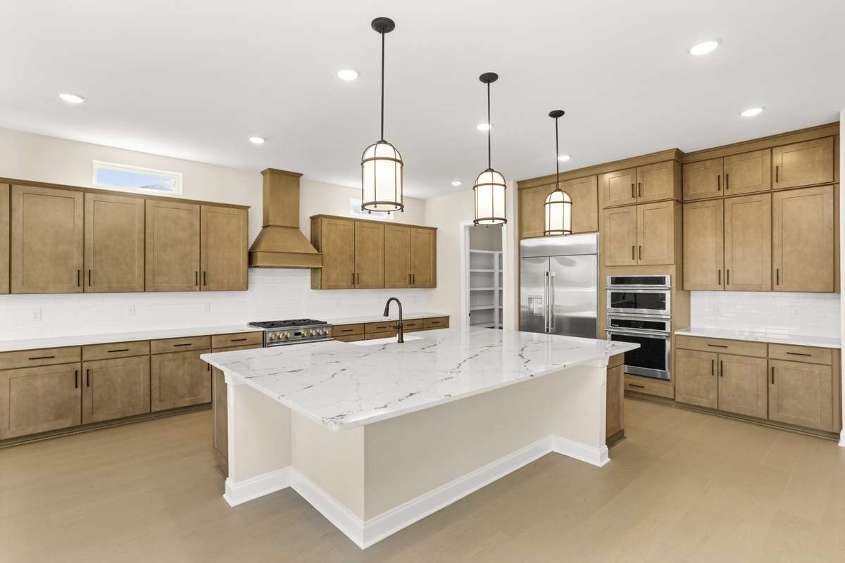 Gourmet kitchen with GE Monogram appliances, gas stove, wall oven and microwave/convection oven.