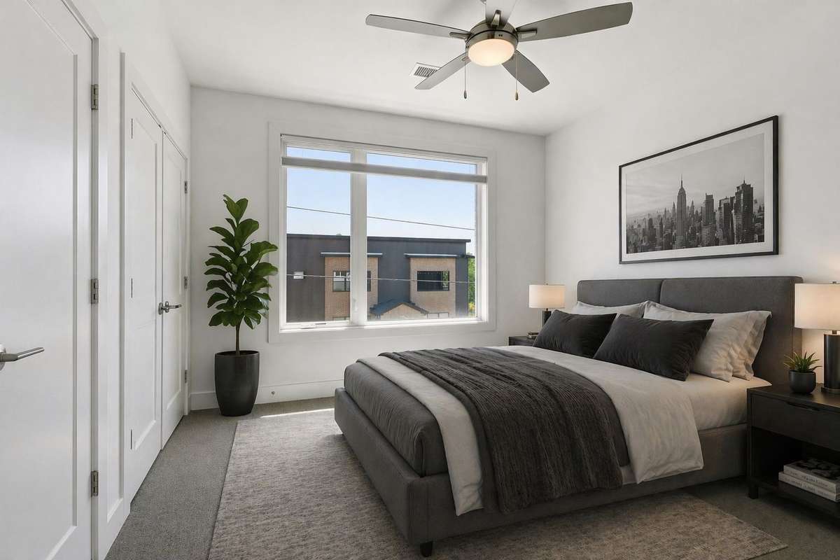 Virtually staged primary bedroom. Double closets, high ceilings and tons of natural light.