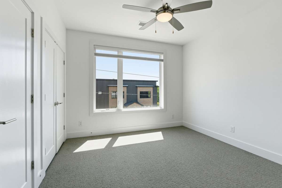 Primary bedroom with double closets. Top down/botton up light filtering shades throughout.