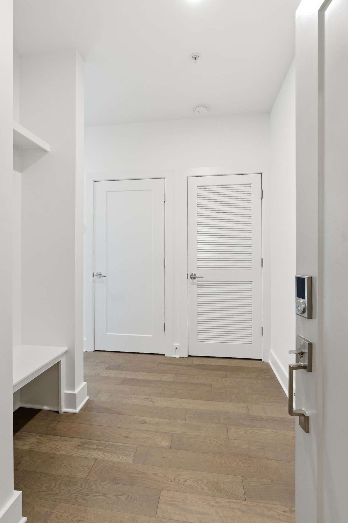 Entryway drop zone including bench and shelves with coat hooks. Easy to stay organized and minimize clutter.