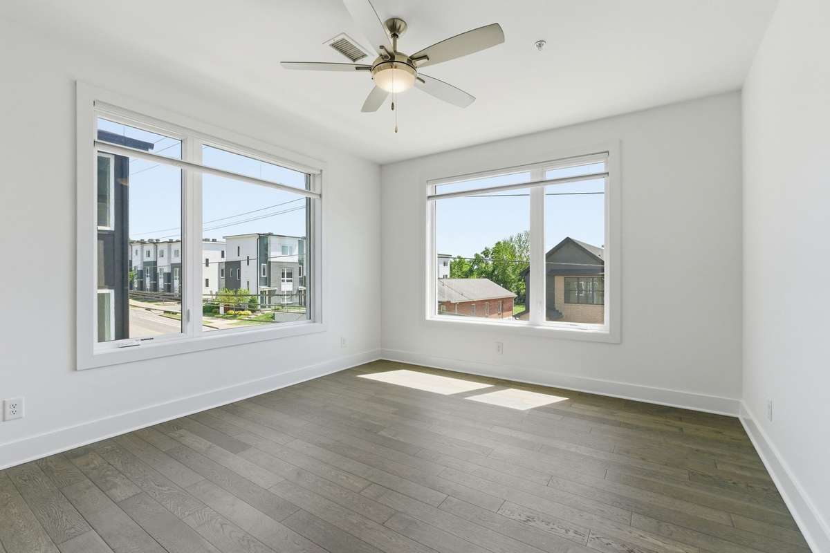 Front facing corner unit with custom cordless light filtering top down/bottom up shades.