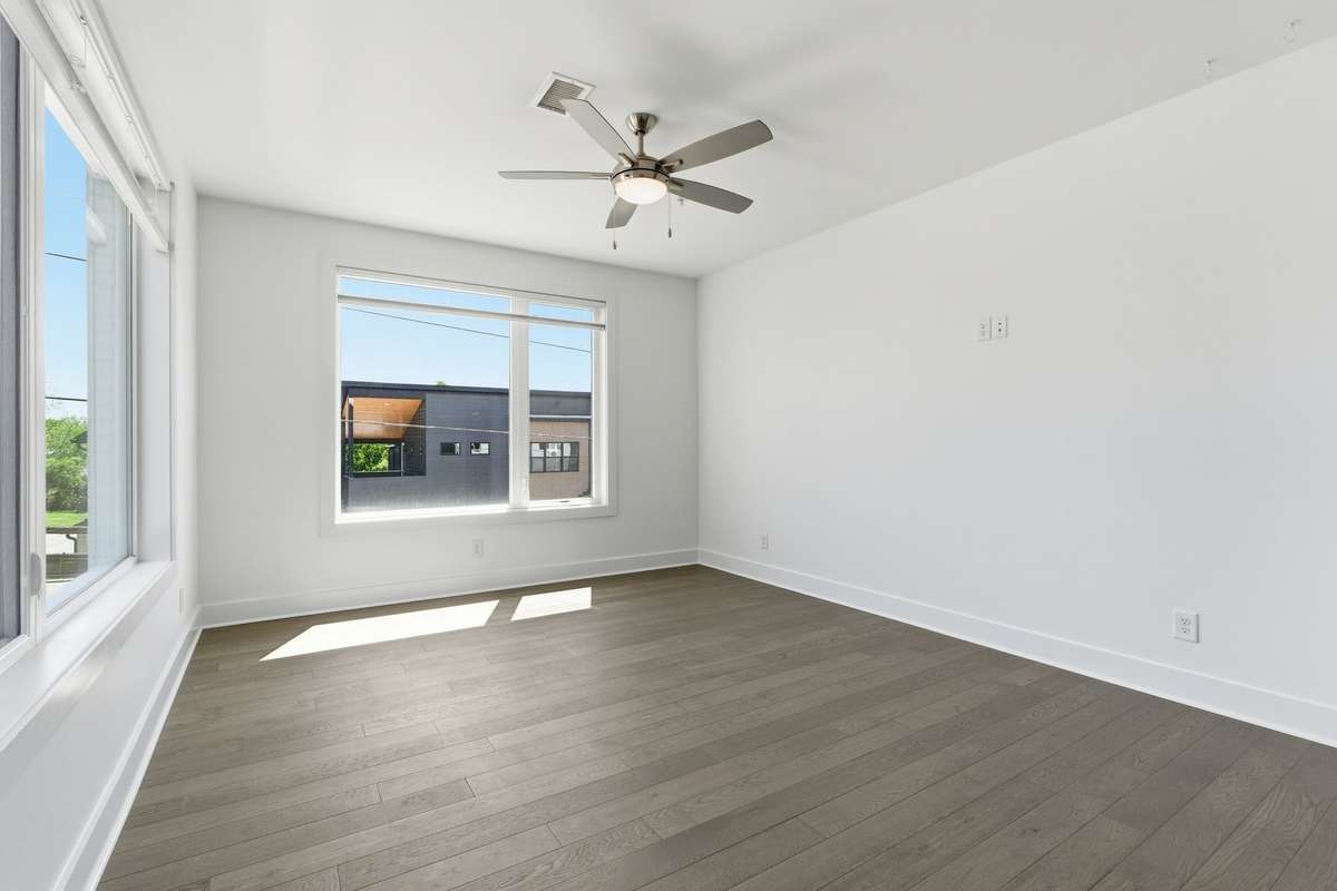 Living room is full of natural light and tall ceilings make this room feel so spacious. Window coverings are cordless light filtering top down/bottom up shades.