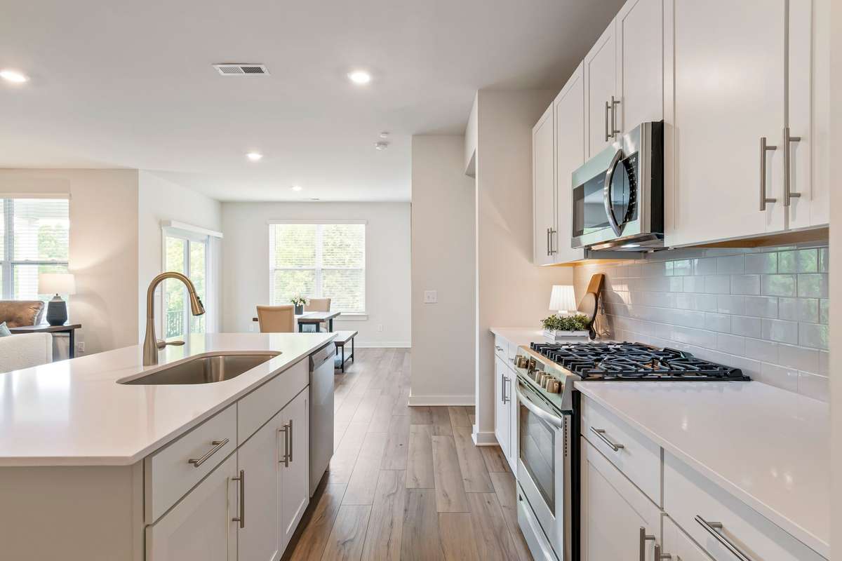 Stainless steel appliances, clean lines, and a functional layout make this kitchen both on trend and practical.