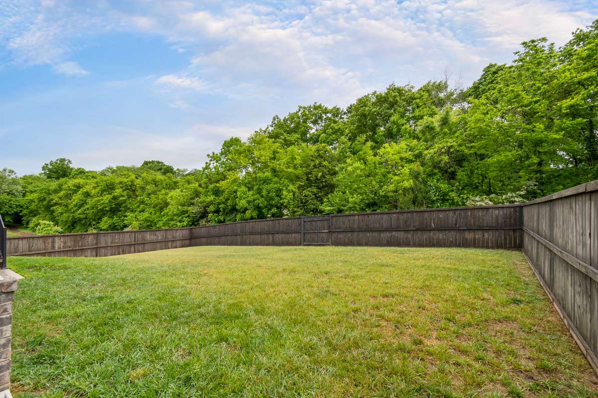 Expansive, fully fenced backyard with plenty of room to play, garden, or entertain.