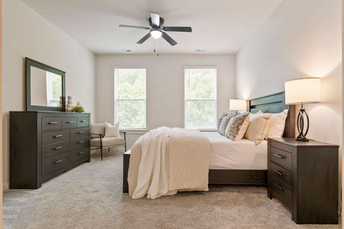 The primary suite overlooks the private backyard, is filled with natural light, and connects seamlessly to an en-suite bathroom.