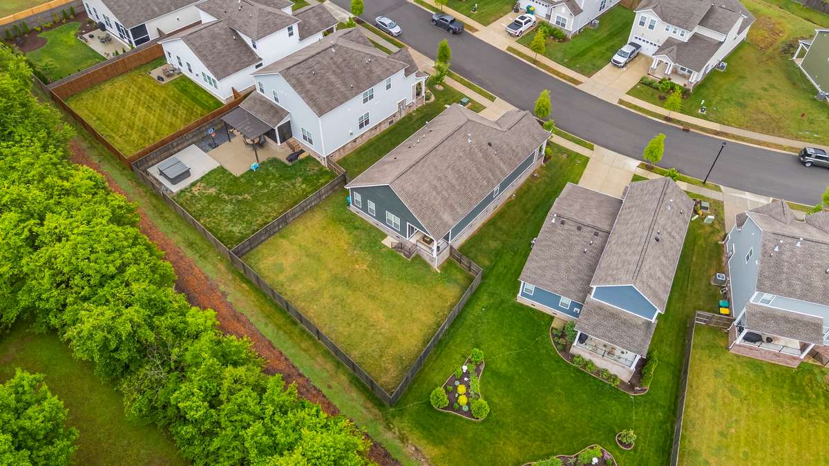 Bird’s-eye view showcasing the fully fenced backyard, ideal lot layout, and one-level footprint—offering both privacy and functionality.