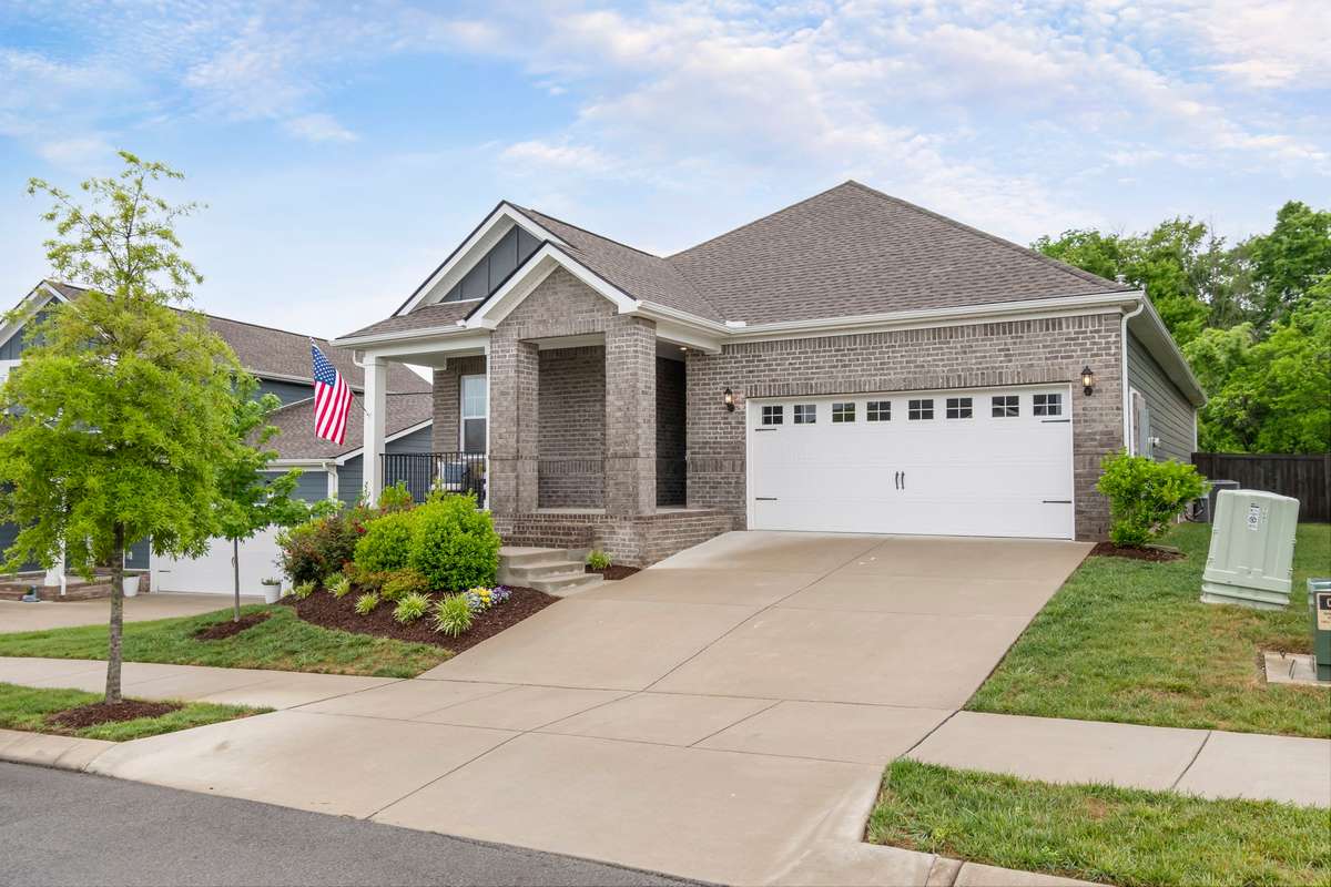 Spacious driveway and attached garage offering convenience and additional storage.