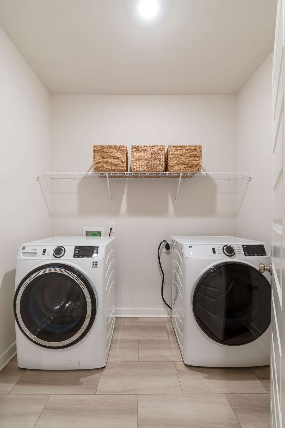 Spacious separate laundry room with storage and easy access for daily convenience.