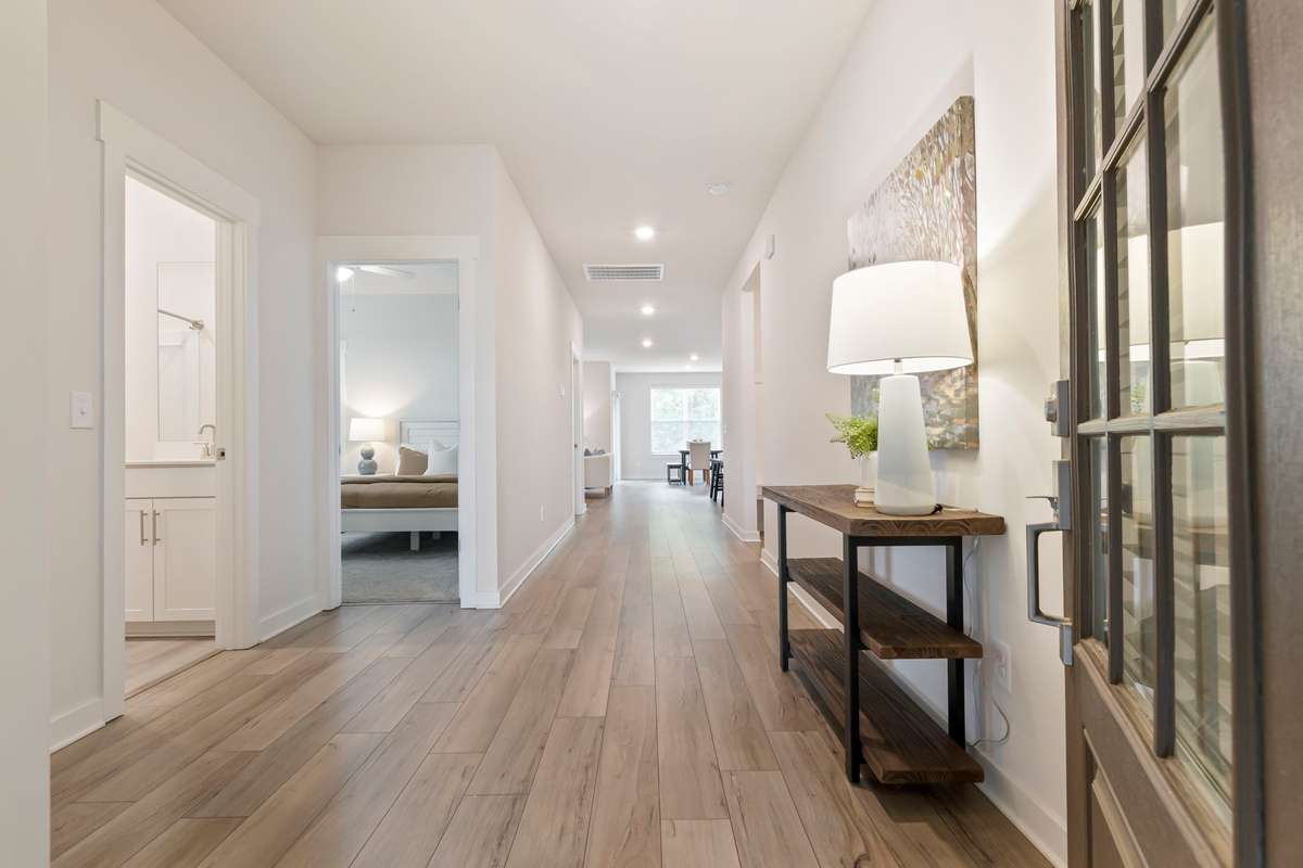 Light-filled entry with wide-plank LVP flooring and a seamless view into the home.