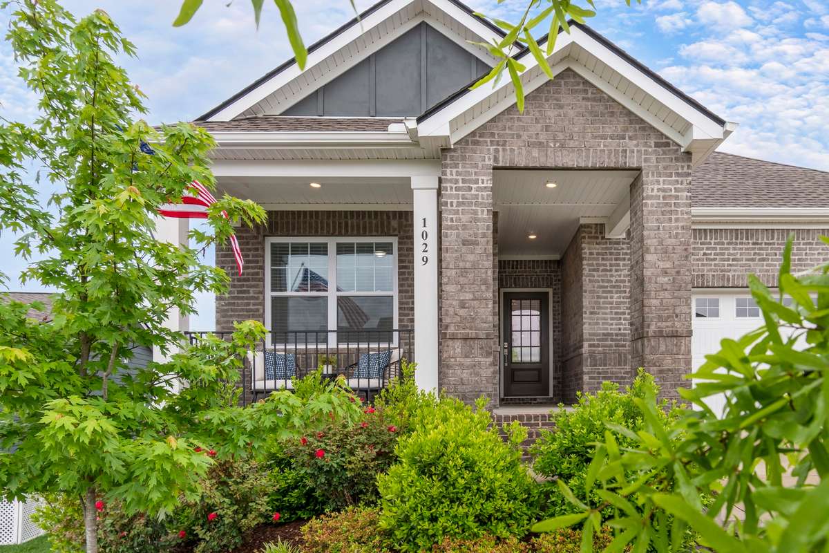 An inviting front porch, manicured landscaping, and classic brick exterior create the perfect first impression—ideal for relaxing evenings and welcoming guests.