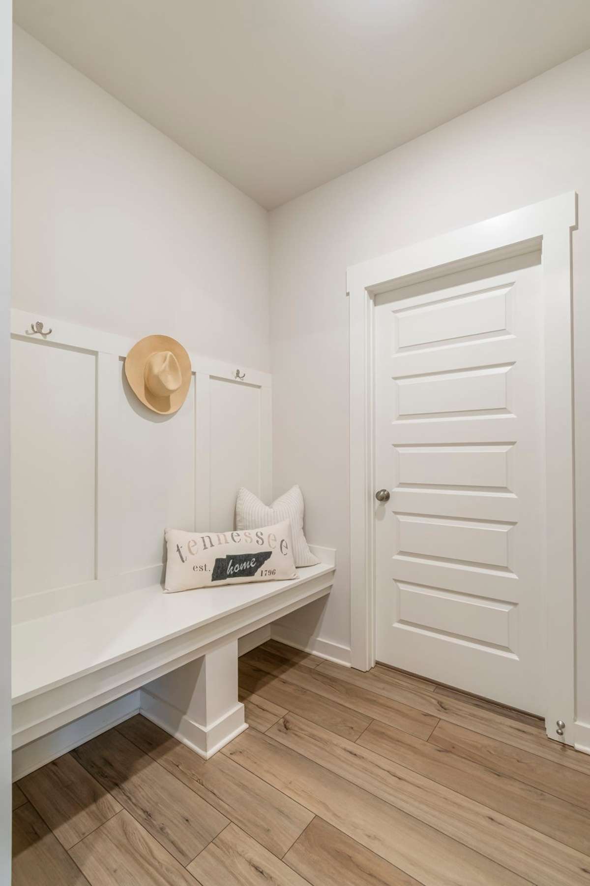 This functional drop zone features a built-in bench and hooks—perfect for everyday organization.