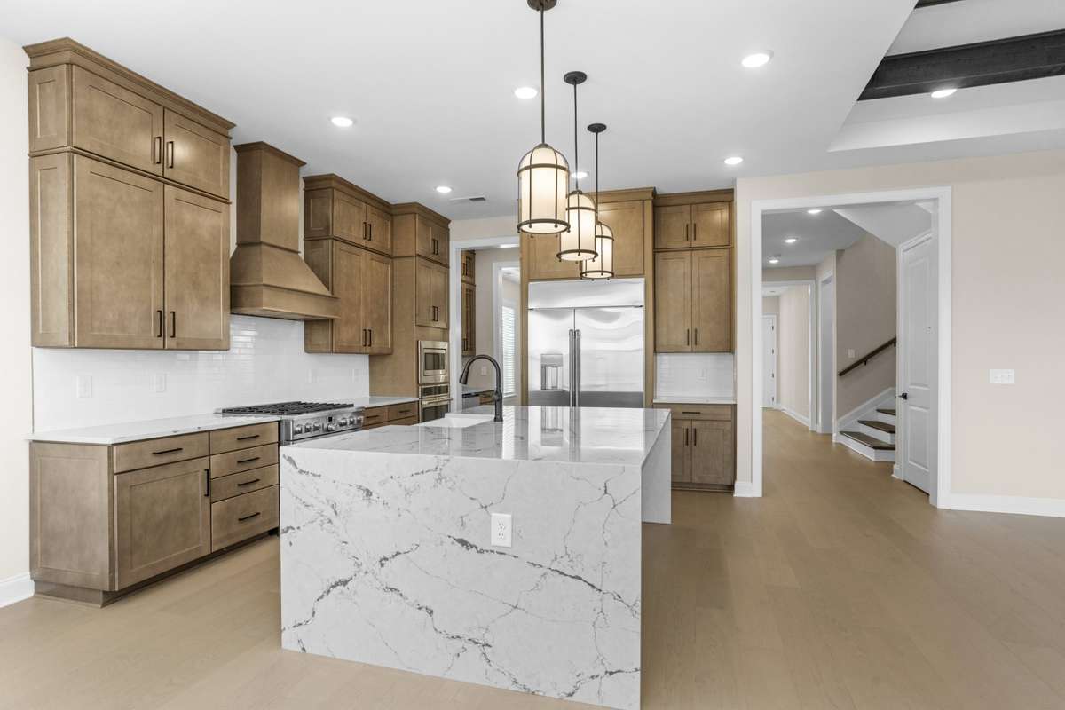 Another view of gourmet kitchen with a view to the front hallway and stairs