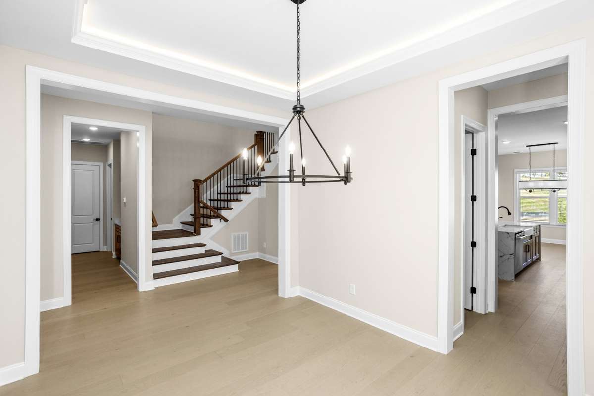 Another view of dining room, looking to hallway to the stairs to the second floor, and a peek through the butler's pantry into kitchen