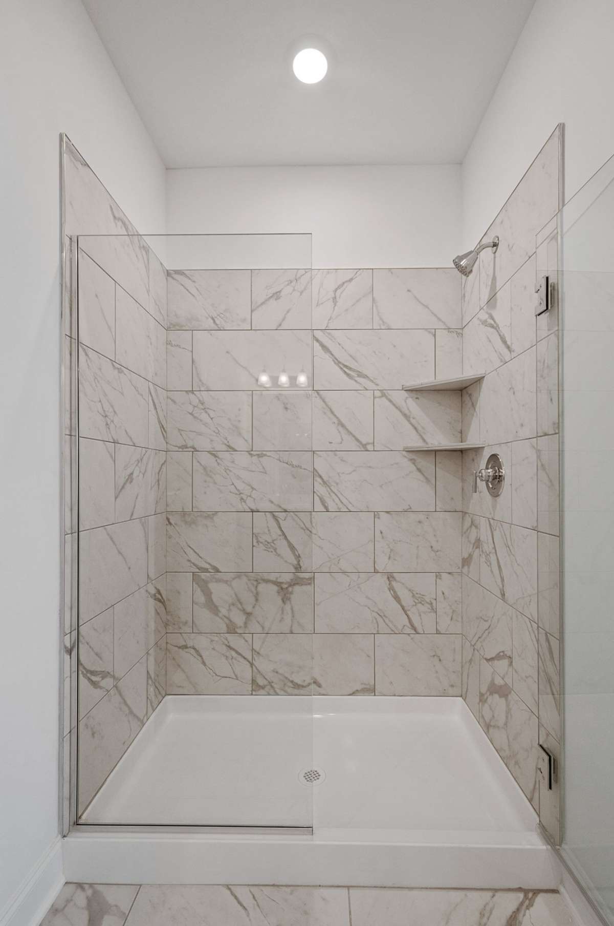 Find a large en-suite bathroom complete with walk-in tile shower + Quartz countertops.