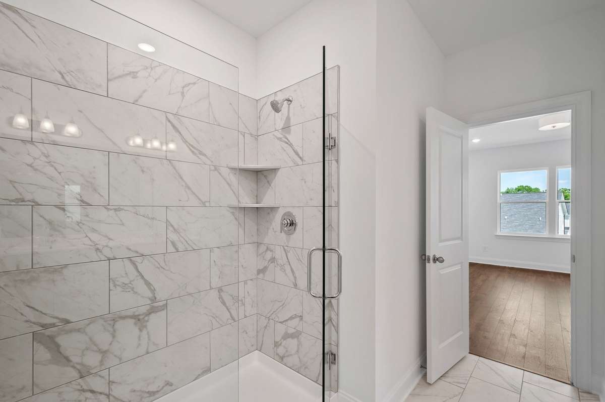 Find a large en-suite bathroom complete with walk-in tile shower + Quartz countertops.