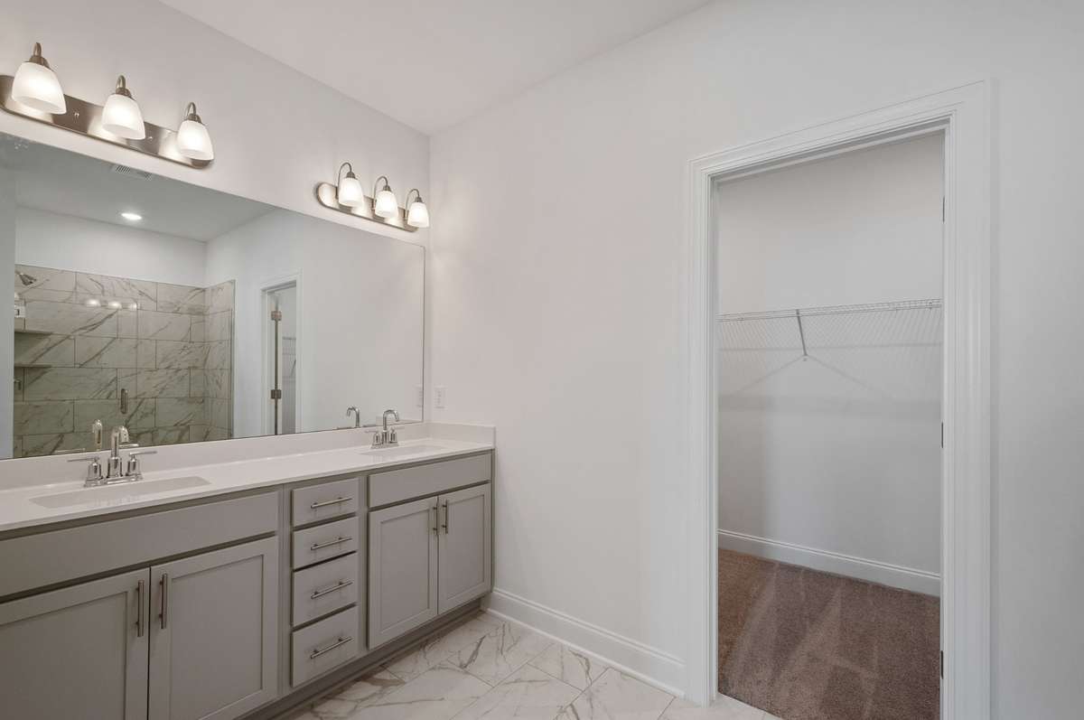 Find a large en-suite bathroom complete with walk-in tile shower + Quartz countertops.