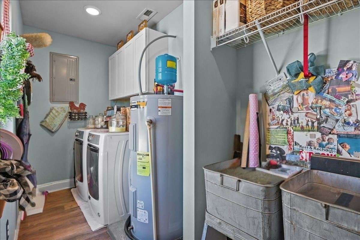 Spacious laundry room with built in cabinetry and shelves!