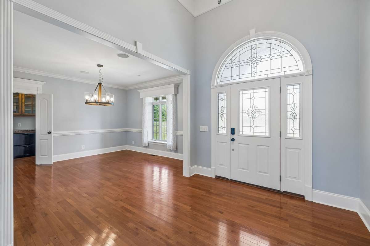 Foyer with elegant Palladium Front Door Entrance with Formal Dinning Room on one side and office on the other