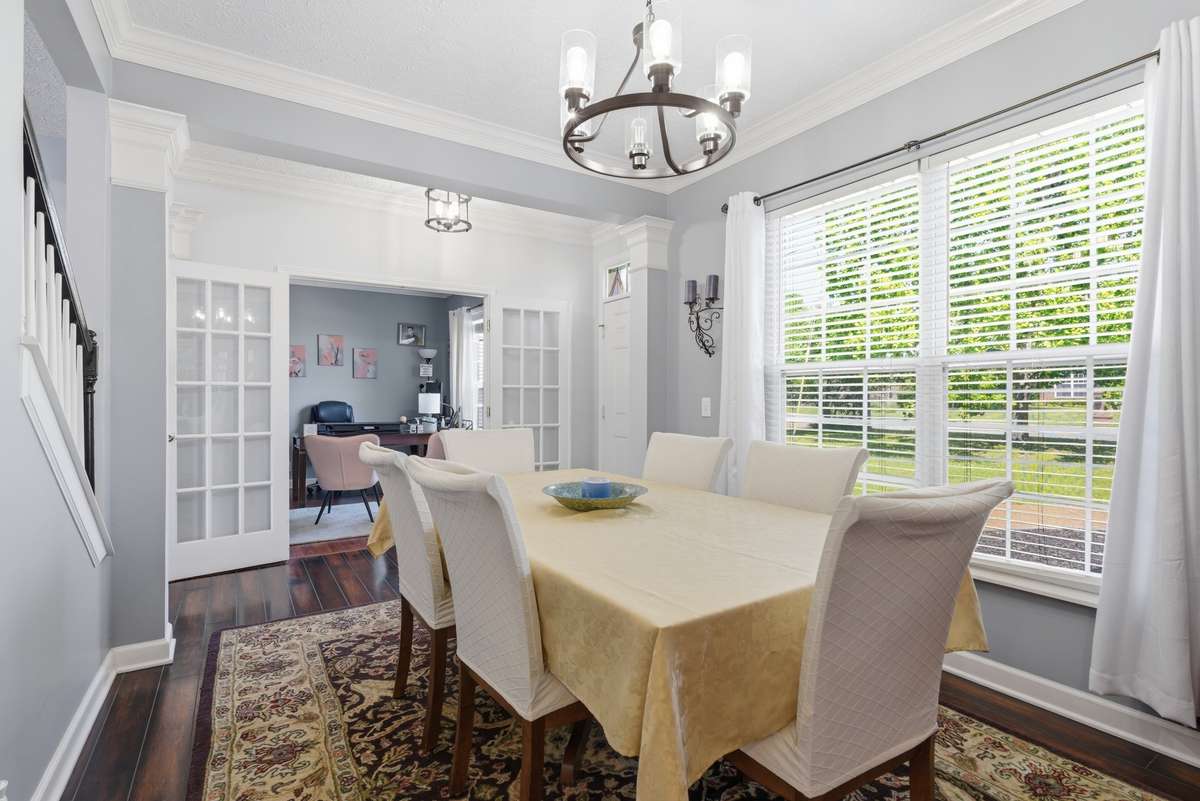 Formal dining room with view of office with french doors in the back.  Both overlooking front yard