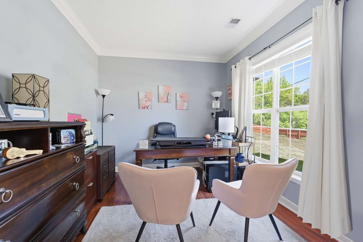 Office with newer wood floors, double crown molding, French doors and overlooks front yard. . .  the perfect work from home space!