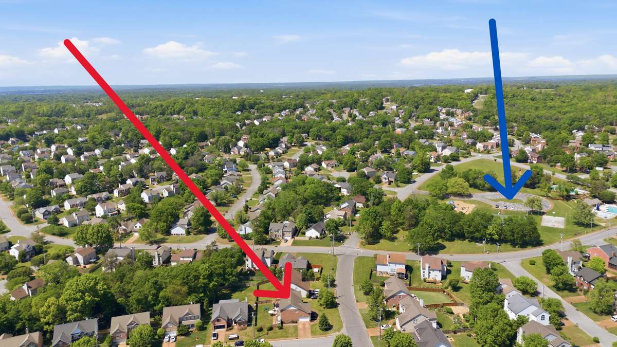 Aerial view.  Blue arrow points to amenity area with pools, tennis and brand new playground!