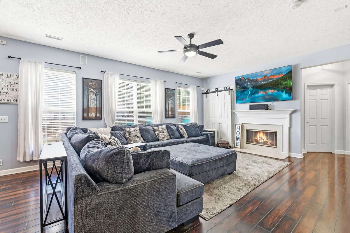 Fireplace with gas logs and barn doors with built in shelves behind