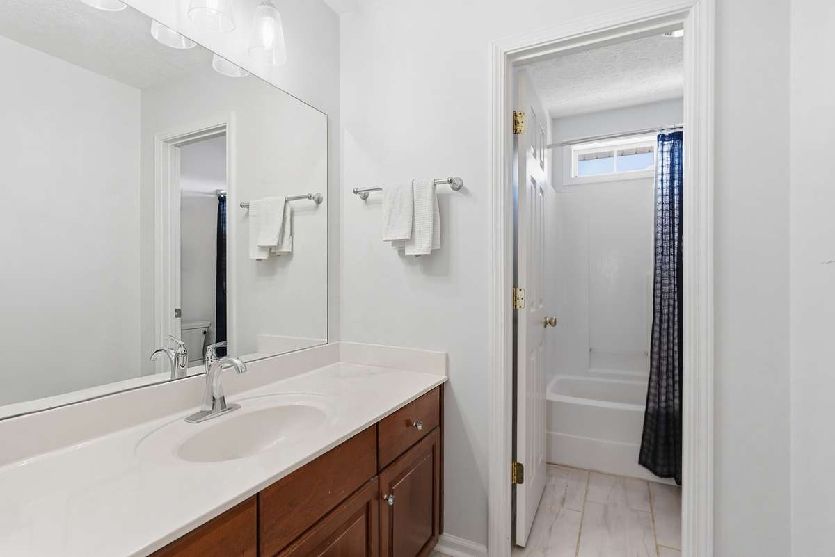Full hall bath upstairs. New tile floor!  Door between the vanity and the toilet and combo shower and tub