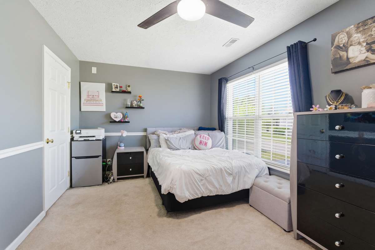 Upstairs front bedroom overlooking front yard with newer carpet and ceiling fan.  Largest spare bedroom could easily be bonus/game room