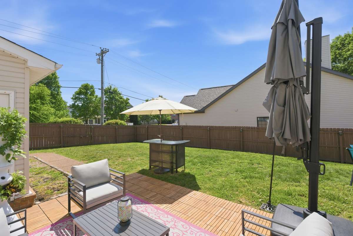 Another view of the backyard.  Aggregate sidewalk leads from back patio to driveway
