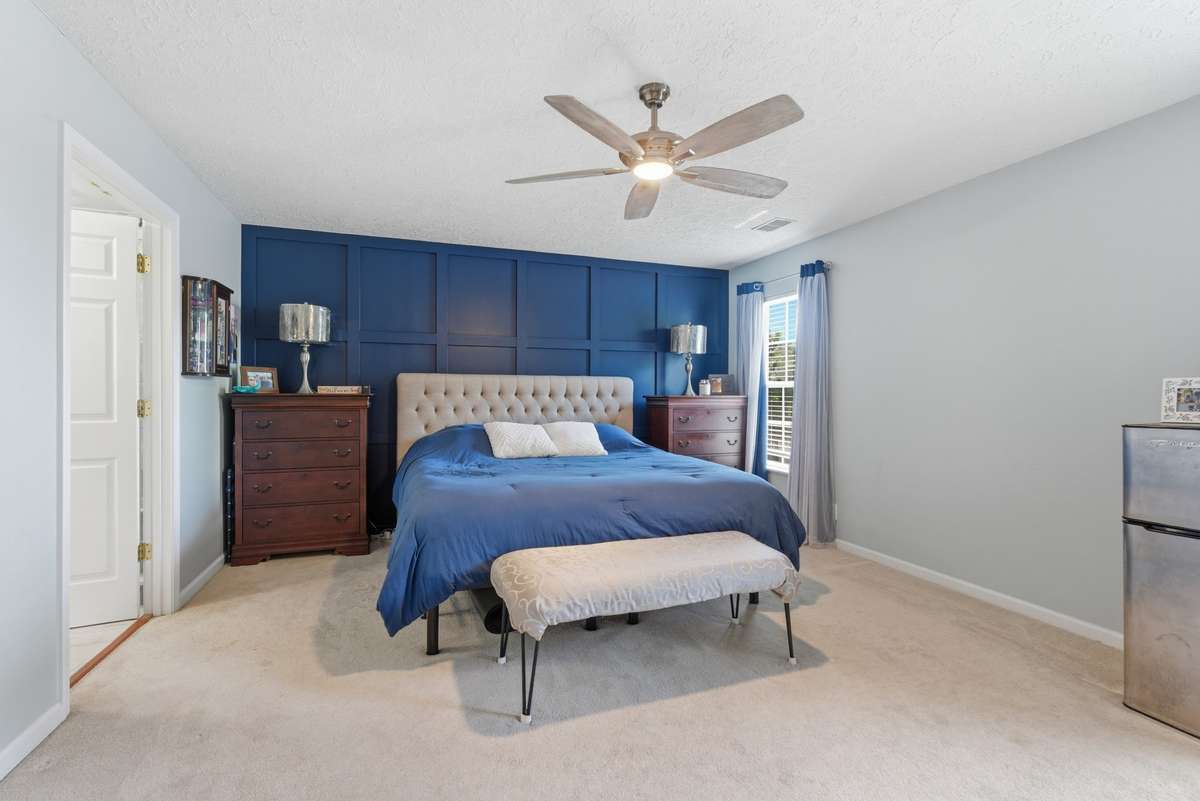 Primary suite. . .with ceiling fan and custom decor wall!