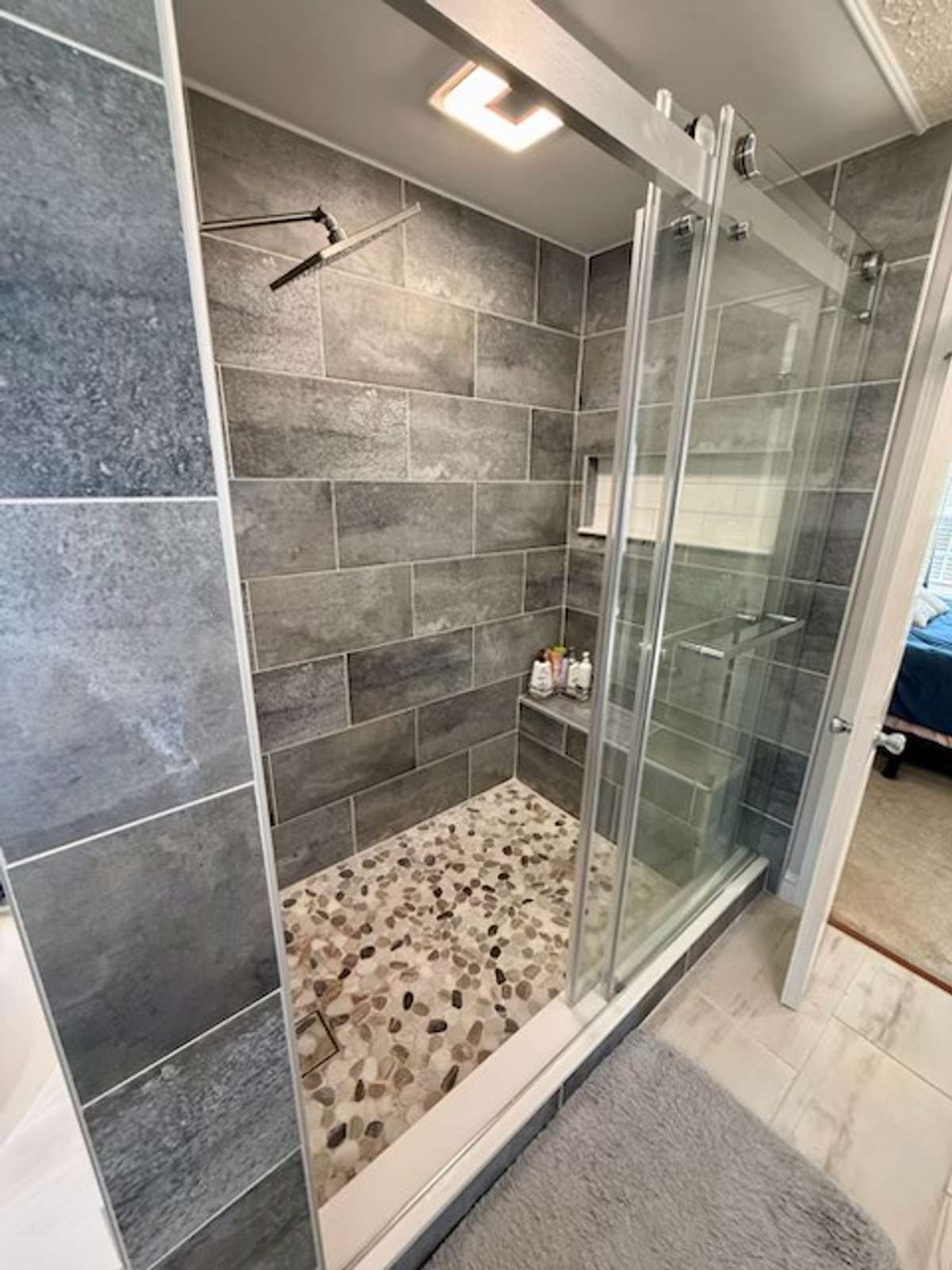 Brand new 4x6 custom tile shower with rainfall shower head and hand-held combo. Shower exhaust fan has bluetooth speaker and night light features.