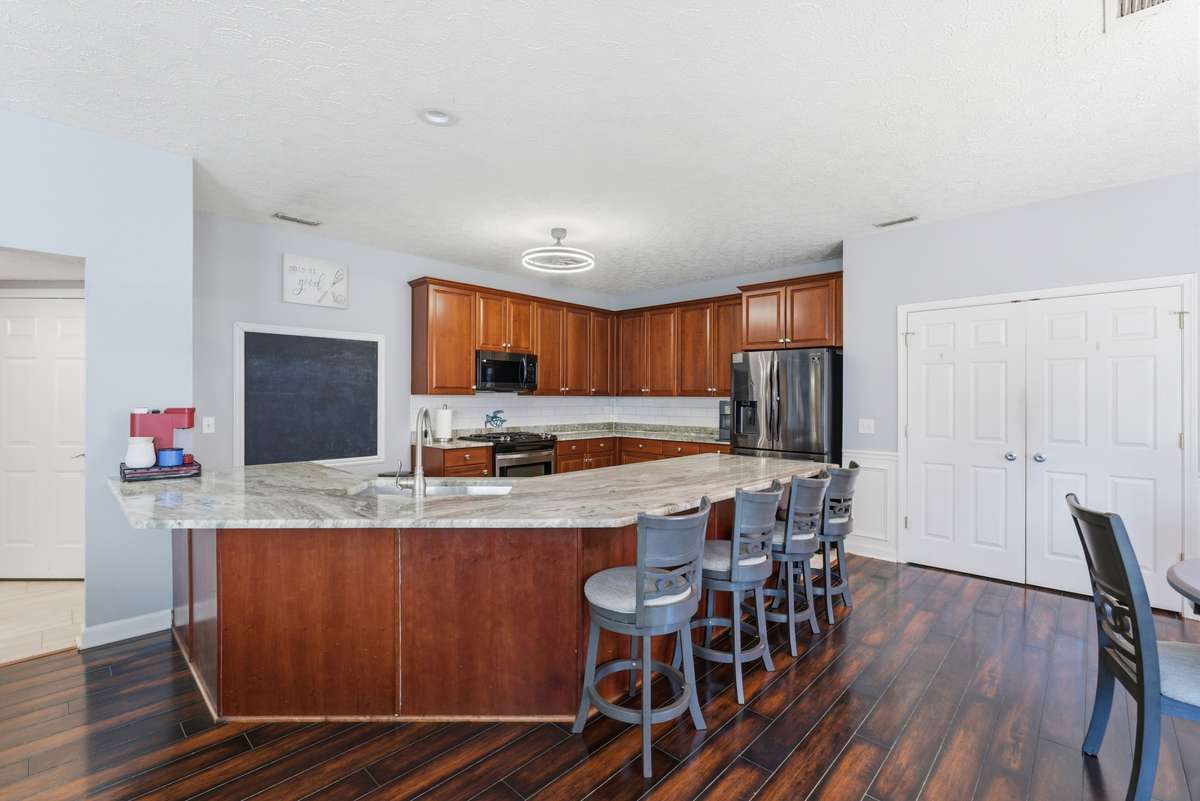 Must see kitchen with new granite countertops, wood floors, new light fixtures and double door pantry