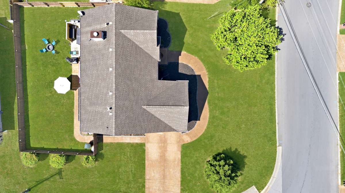 Aerial view of the home and yard.  Grass has been virtually brighten/greened