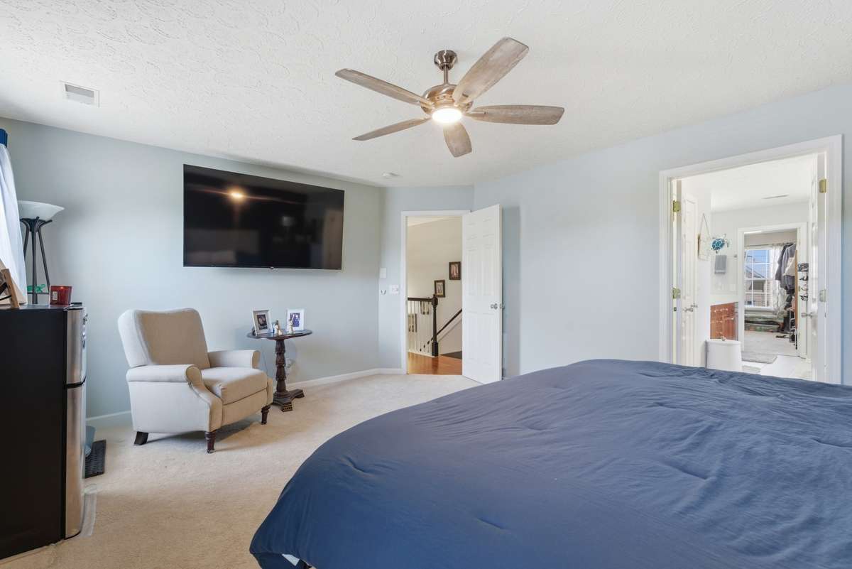 Another view of the primary suite with new ceiling fan