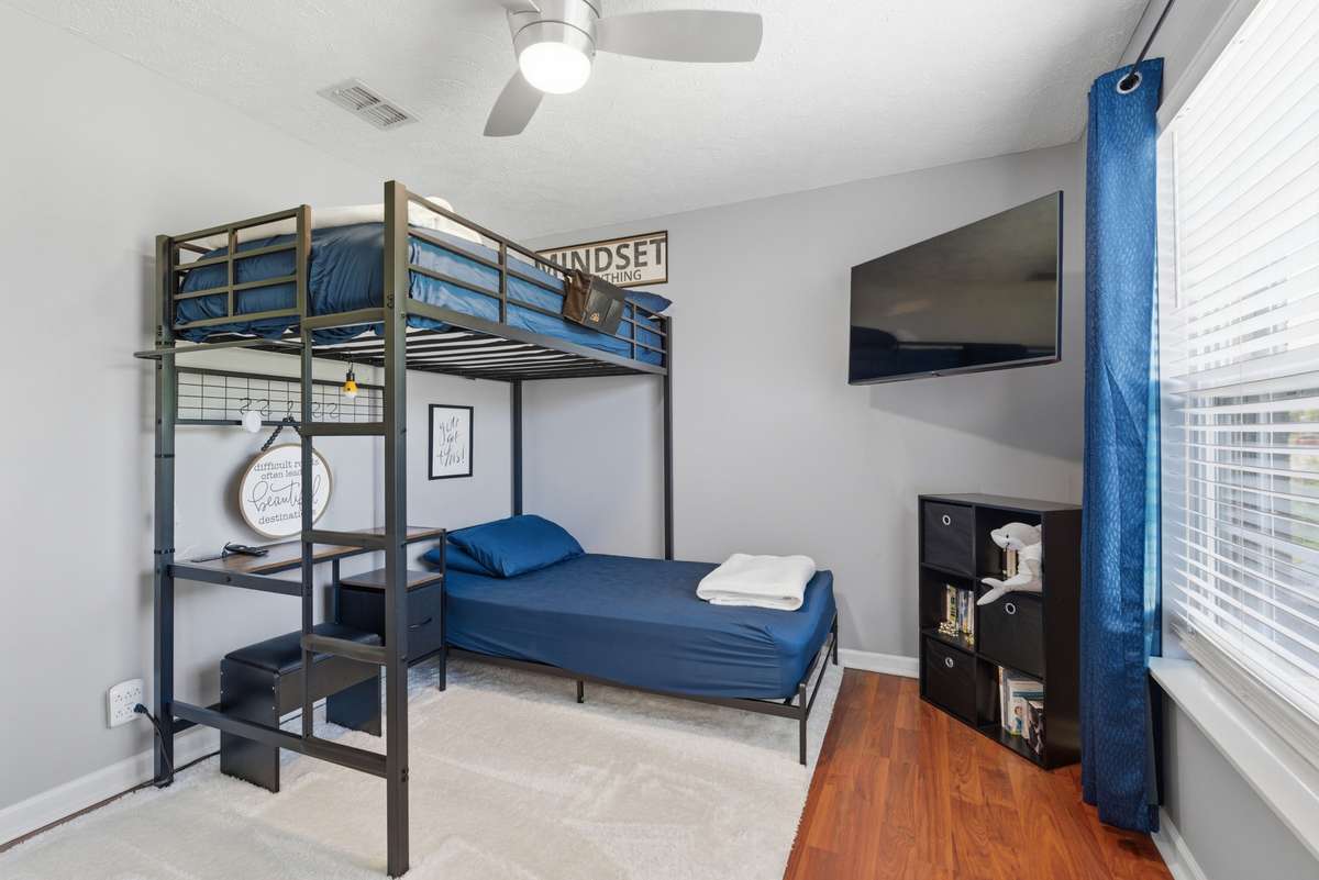 Front spare bedroom with ceiling fan overlooks the front yard. New flooring and ceiling fan