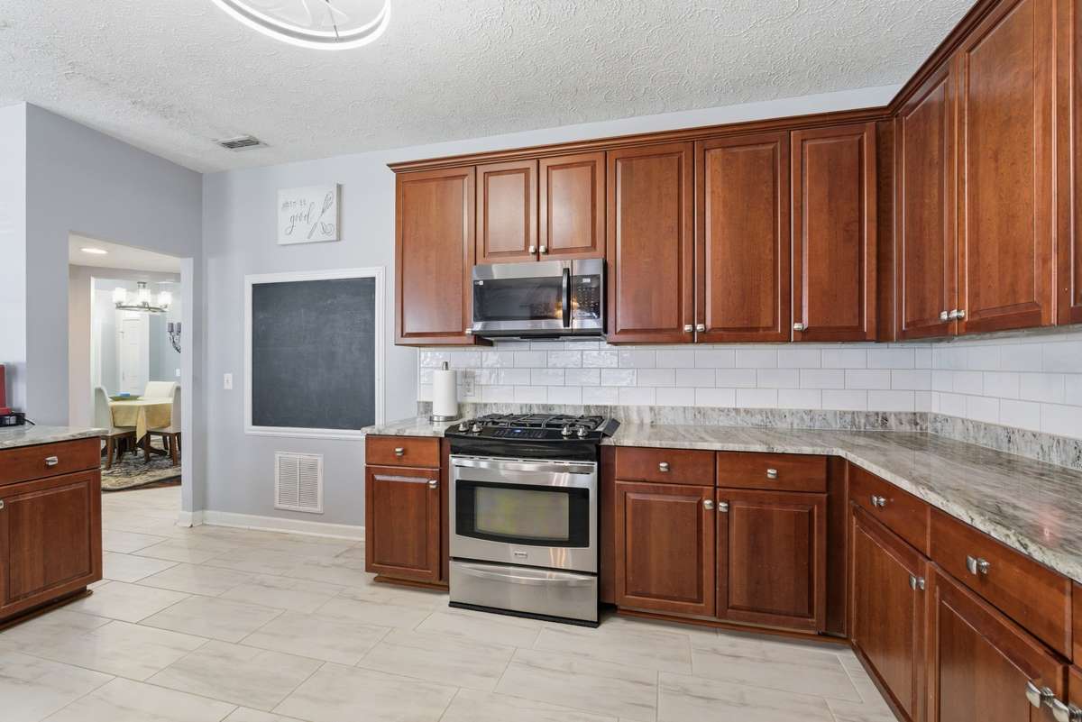 Stainless steel appliances. . . new countertop and backsplash