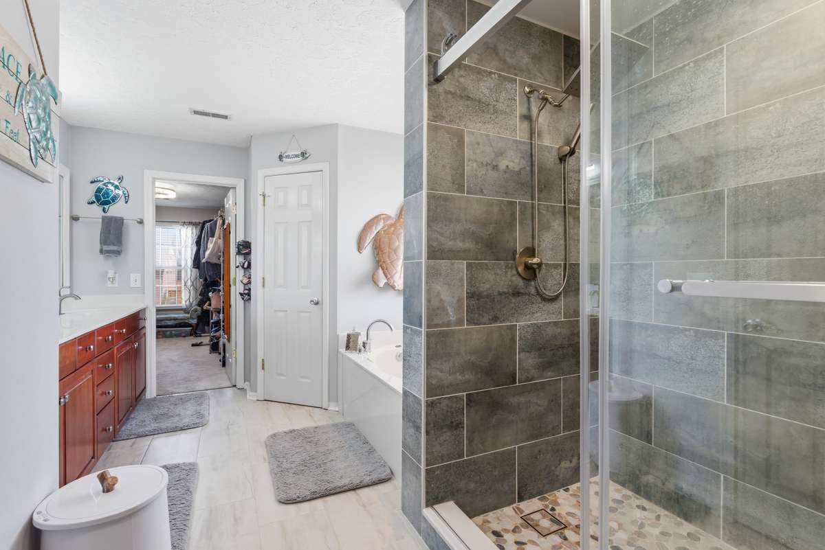 You will love this bathroom!  Long double sink vanity, 2 huge walk-in closets, separate tub and new custom tile walk-in shower